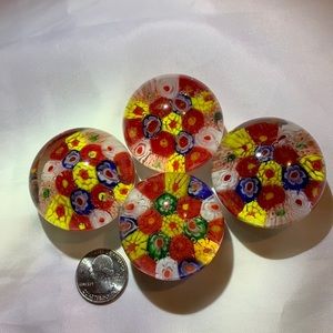 Set of four small glass paperweights